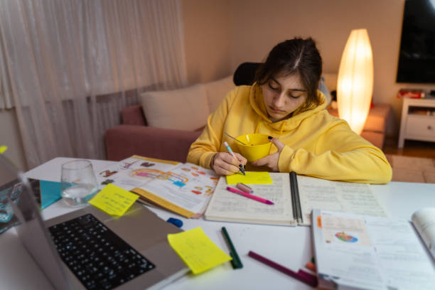 Girl student writing essays with concentration