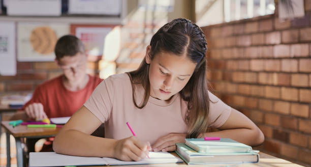 Students writing essays in the examination hall