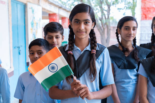 Students stand with the flag of India and demonstrate patriotism