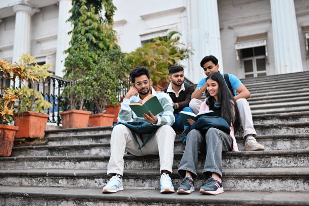Students sit on the stairs outside the school and read a book