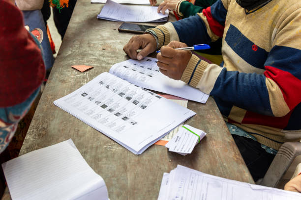 Polling staff searching for voter's name from voter list
