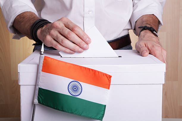 Voter casting their vote with ballot paper