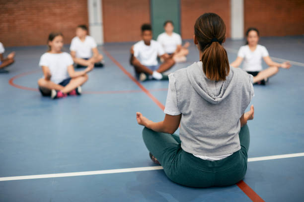 Yogacharya is teaching meditation to young children