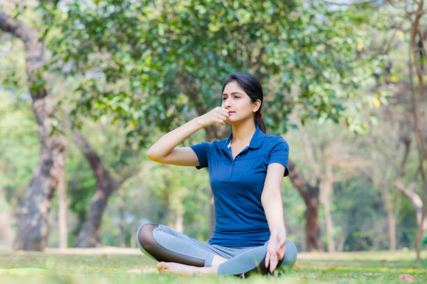College student sitting in solitude meditating