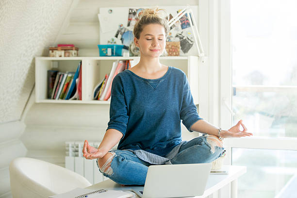 College student meditating in the study room