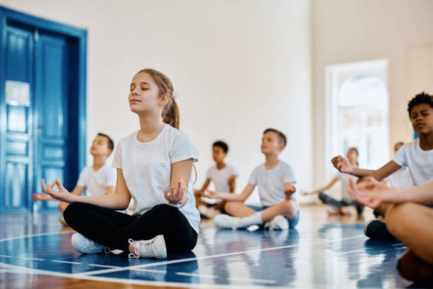 Children in the group are sitting and meditating