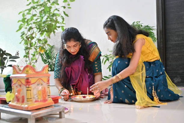 Woman prepares puja thali with her daughter