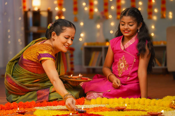 A woman lighting a lamp and her daughter symbolize the spiritual
