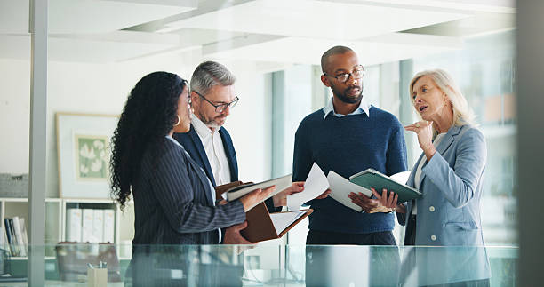 Businessmen discussing business with employees